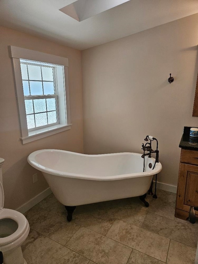 bathroom with vanity, toilet, and a bathing tub