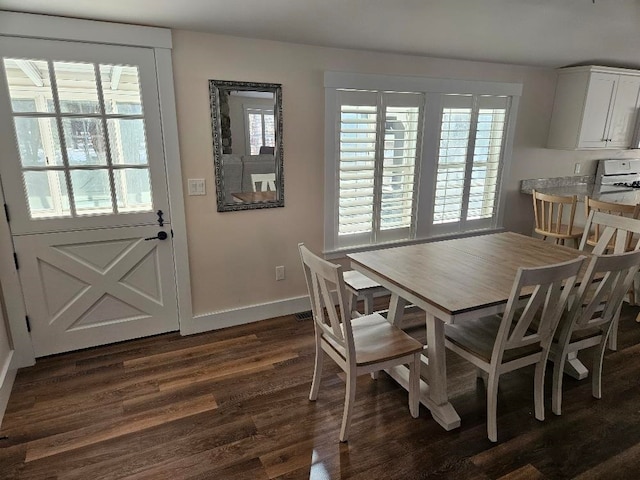 dining space with dark wood-type flooring