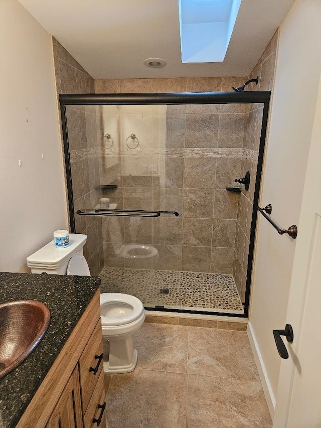 bathroom with a shower with door, toilet, and vanity