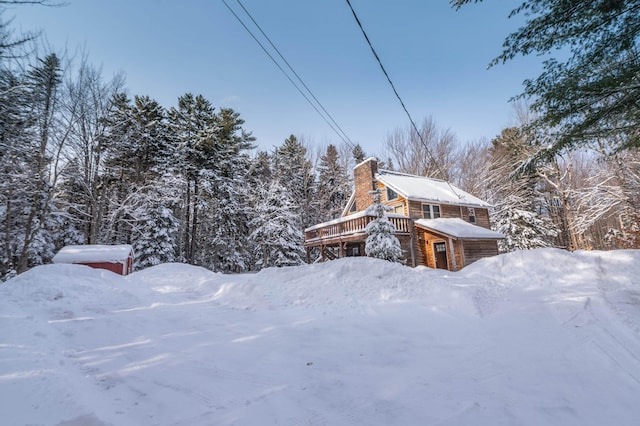 yard layered in snow featuring a wooden deck