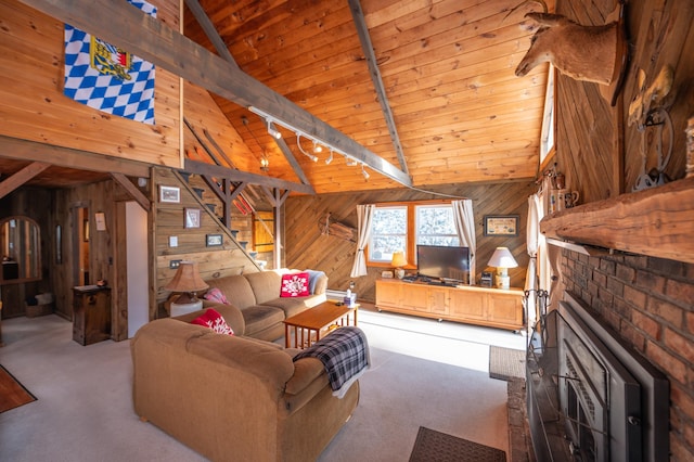 carpeted living room with wood ceiling, wood walls, and rail lighting