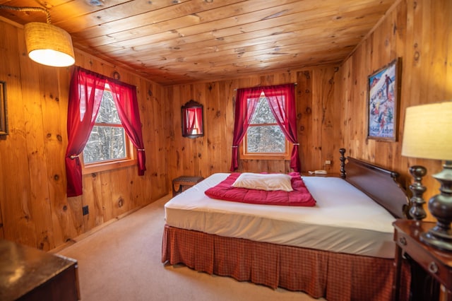 carpeted bedroom featuring wood ceiling and wooden walls