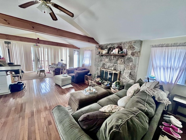 living room featuring hardwood / wood-style flooring, ceiling fan, lofted ceiling, and a fireplace