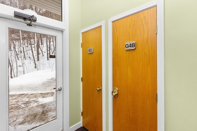 view of snow covered property entrance