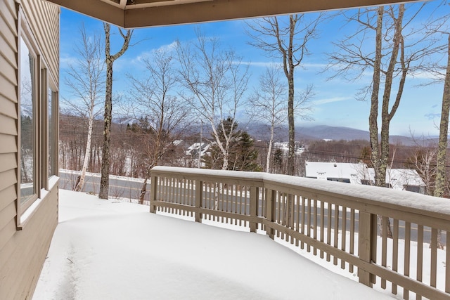 snow covered deck featuring a mountain view