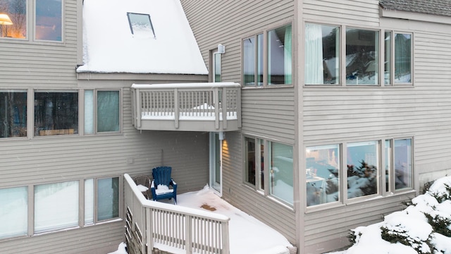 view of snow covered exterior with a balcony