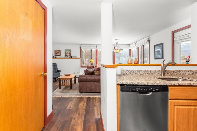 kitchen with dishwasher, light stone countertops, sink, and dark wood-type flooring