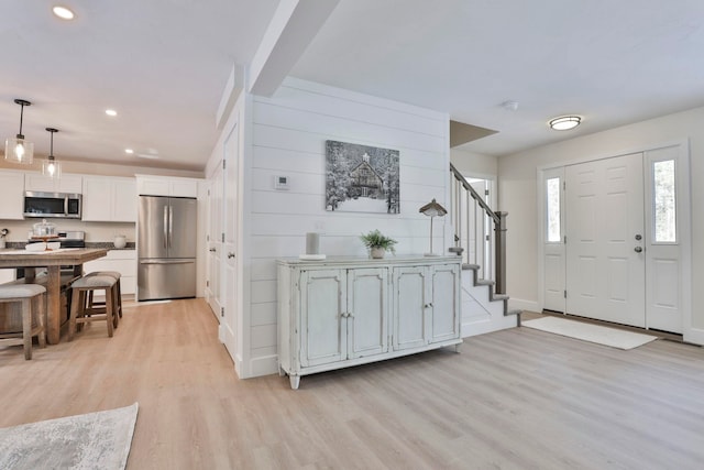 foyer entrance with light hardwood / wood-style floors