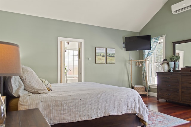 bedroom with connected bathroom, dark hardwood / wood-style flooring, vaulted ceiling, and an AC wall unit