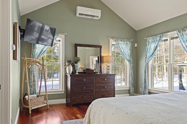 bedroom with multiple windows, vaulted ceiling, dark wood-type flooring, and a wall unit AC