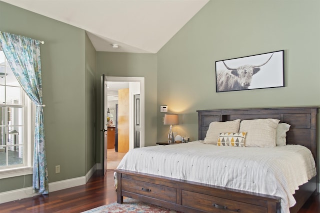 bedroom featuring dark wood-type flooring and vaulted ceiling