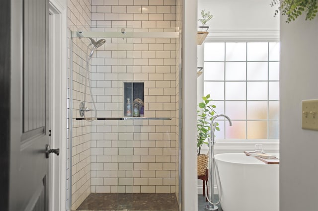 bathroom with plenty of natural light and a shower with door