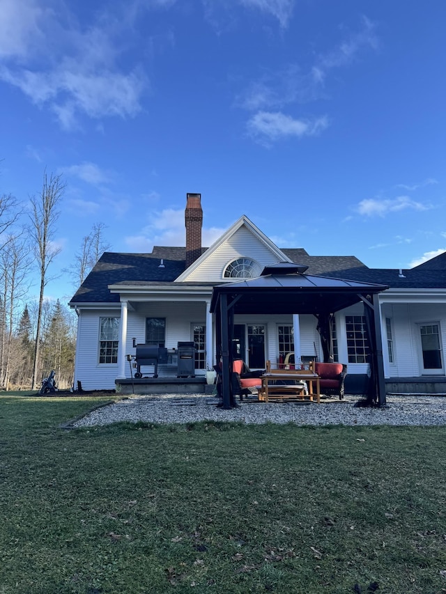 rear view of house with a lawn