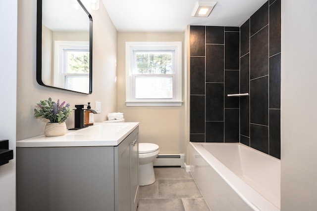 full bathroom with vanity, a baseboard heating unit, tiled shower / bath combo, and toilet