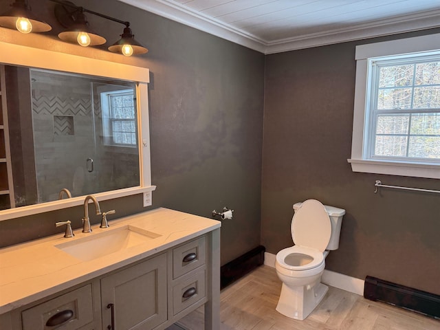 full bathroom featuring toilet, ornamental molding, a shower stall, baseboard heating, and vanity