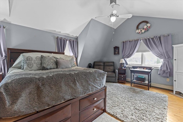 bedroom featuring light hardwood / wood-style flooring, ceiling fan, and vaulted ceiling