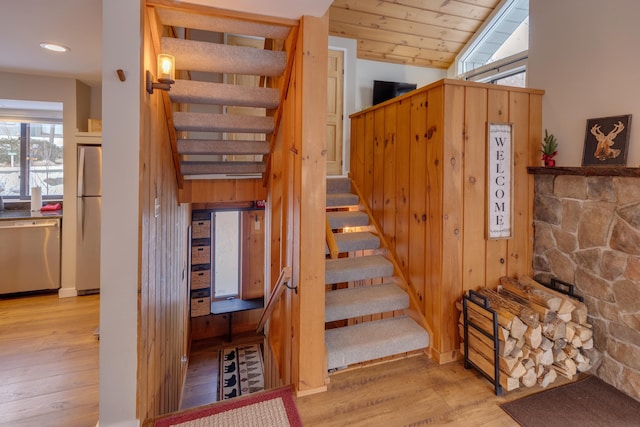 staircase with hardwood / wood-style floors, lofted ceiling, and wood ceiling