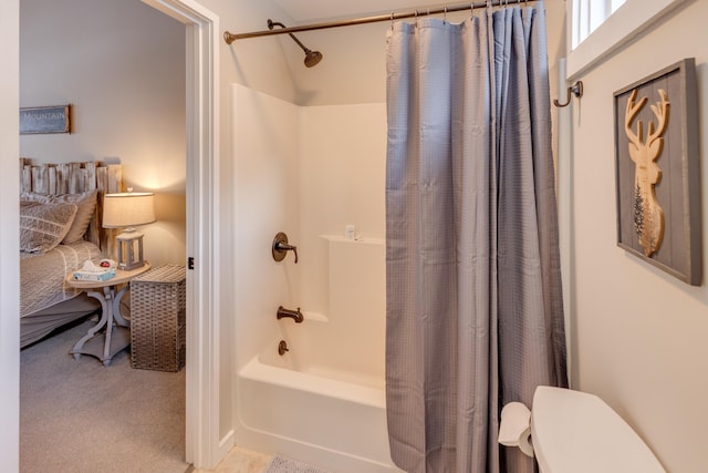 bathroom with shower / tub combo with curtain and toilet