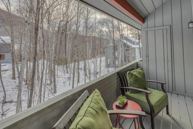 view of snow covered back of property