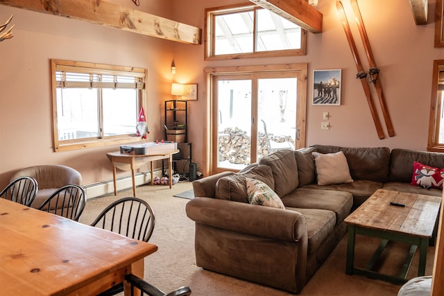 carpeted living room with a baseboard heating unit and beam ceiling