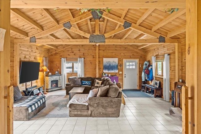 living room with light tile patterned floors, wood ceiling, beamed ceiling, and wood walls