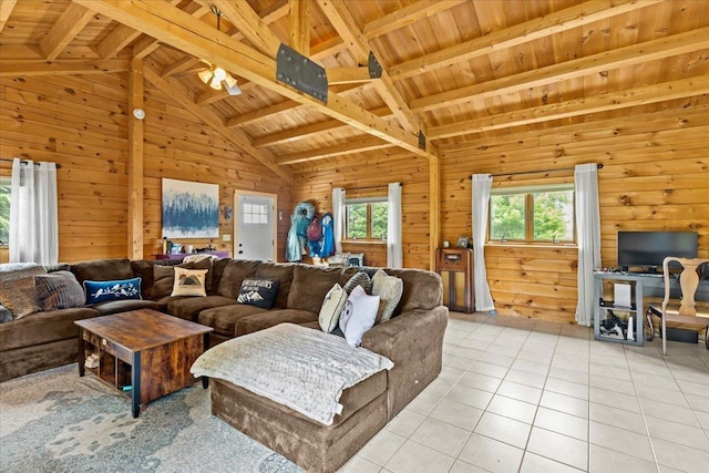 living room featuring beamed ceiling, wood walls, wooden ceiling, and light tile patterned floors