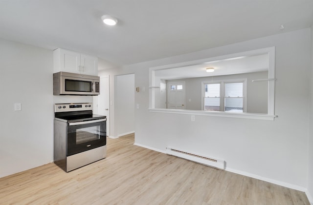 kitchen featuring stainless steel appliances, white cabinetry, light wood-type flooring, and baseboard heating