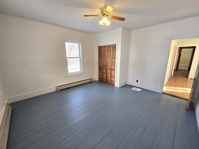 spare room with ceiling fan, dark hardwood / wood-style floors, and baseboard heating