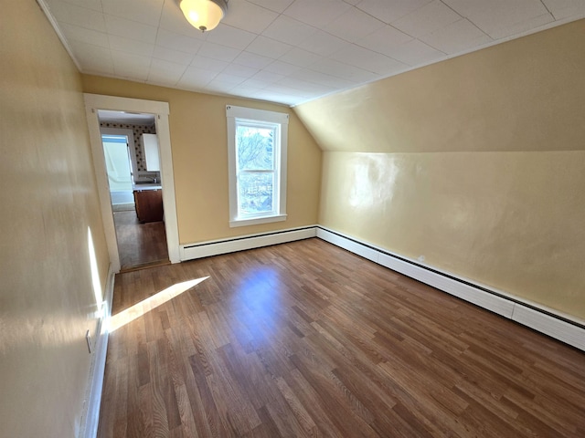 bonus room with wood-type flooring, vaulted ceiling, and a baseboard radiator