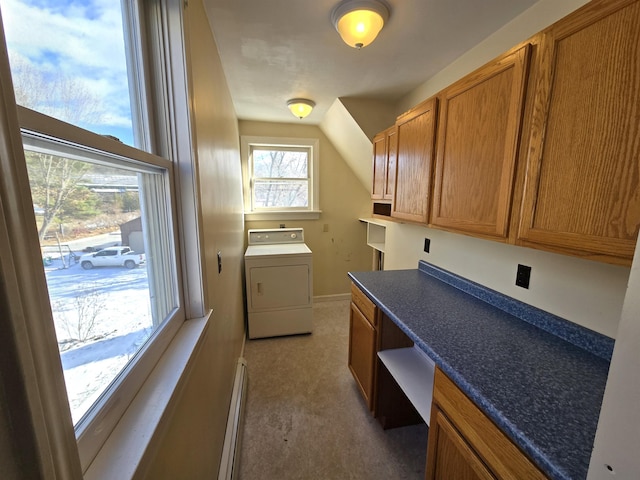 laundry room featuring baseboard heating, a healthy amount of sunlight, washer / dryer, and light carpet