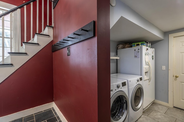 laundry room featuring light tile patterned flooring and separate washer and dryer