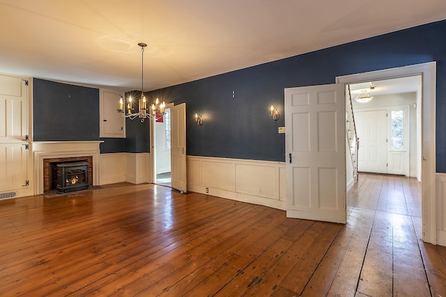 unfurnished living room featuring hardwood / wood-style floors and a notable chandelier