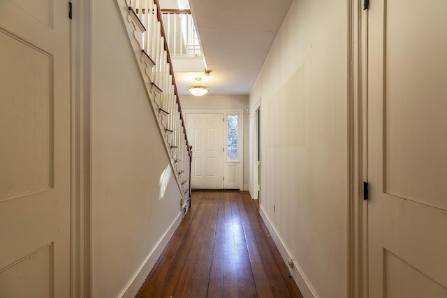 corridor with dark hardwood / wood-style flooring