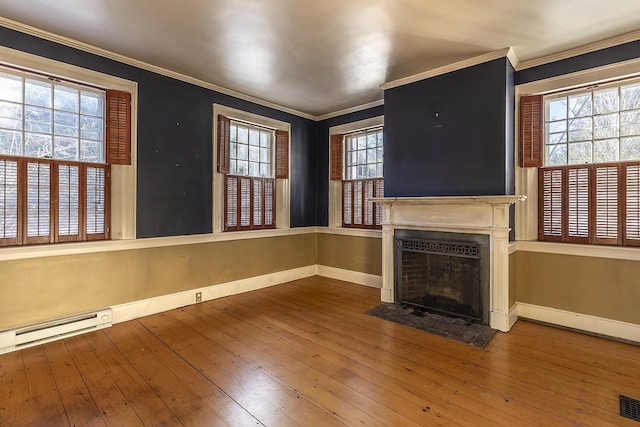 unfurnished living room with crown molding, baseboard heating, and hardwood / wood-style flooring