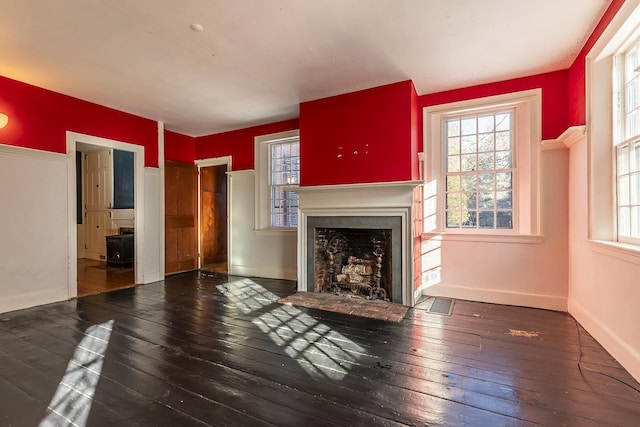 unfurnished living room featuring dark hardwood / wood-style flooring