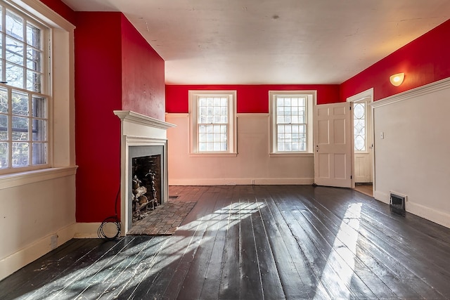 unfurnished living room featuring dark hardwood / wood-style flooring