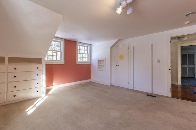 bonus room featuring light colored carpet