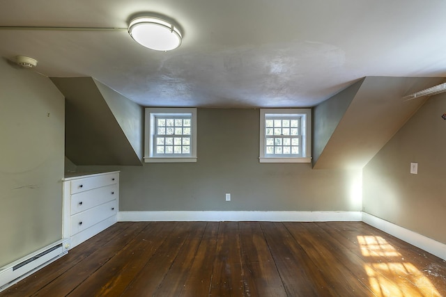 bonus room featuring baseboard heating and dark hardwood / wood-style flooring