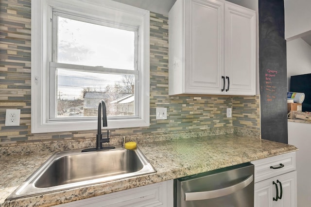 kitchen with white cabinetry, dishwasher, sink, and decorative backsplash