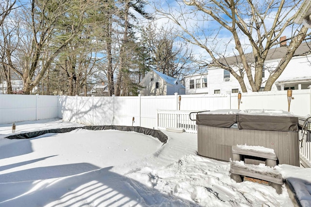 yard layered in snow featuring a hot tub