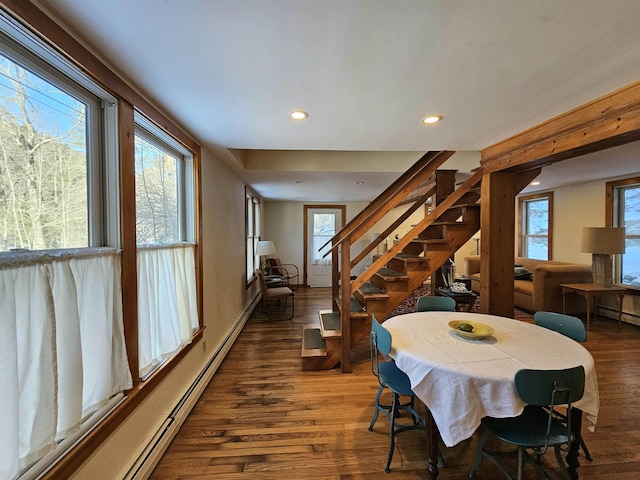 dining area with dark hardwood / wood-style flooring and a baseboard heating unit