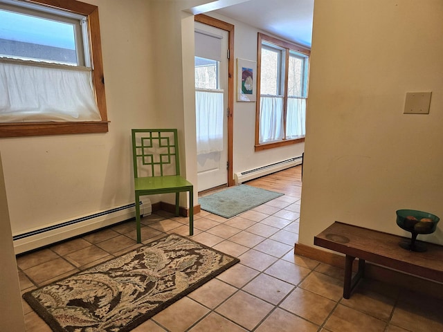 doorway featuring light tile patterned flooring and a baseboard heating unit