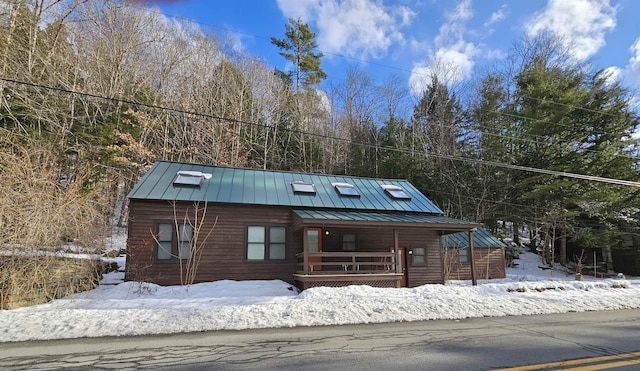 log-style house with covered porch