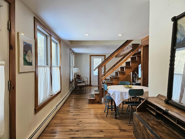 dining room with hardwood / wood-style floors and baseboard heating