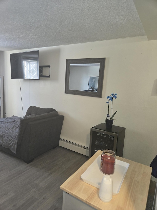 interior space with baseboard heating, dark hardwood / wood-style floors, and a textured ceiling