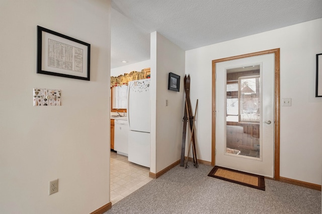 interior space featuring light carpet and a textured ceiling