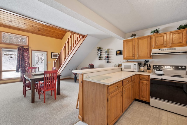 kitchen with electric range, wooden ceiling, vaulted ceiling, light colored carpet, and kitchen peninsula