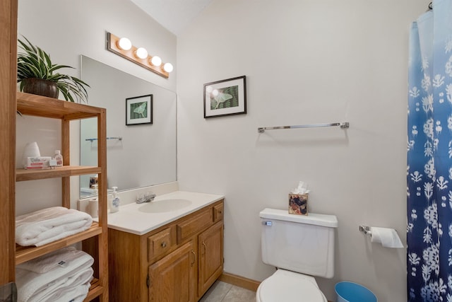 bathroom with vanity, toilet, and tile patterned flooring