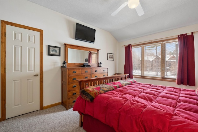 bedroom featuring ceiling fan, vaulted ceiling, and light carpet