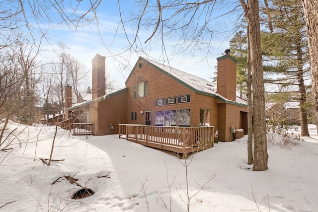 snow covered property featuring a deck